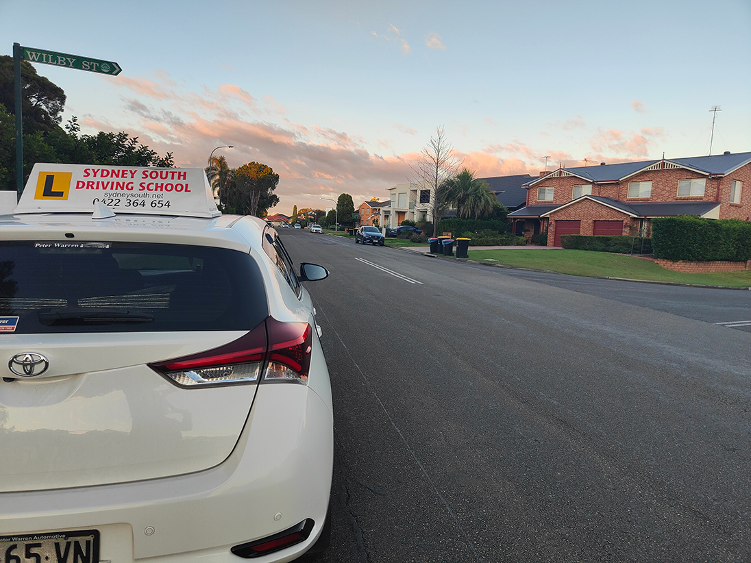 Driving instructor coaching a learner driver in an automatic training car in Cabramatta NSW